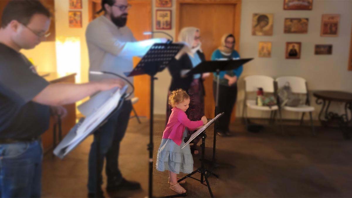 Child helps sing the prayers